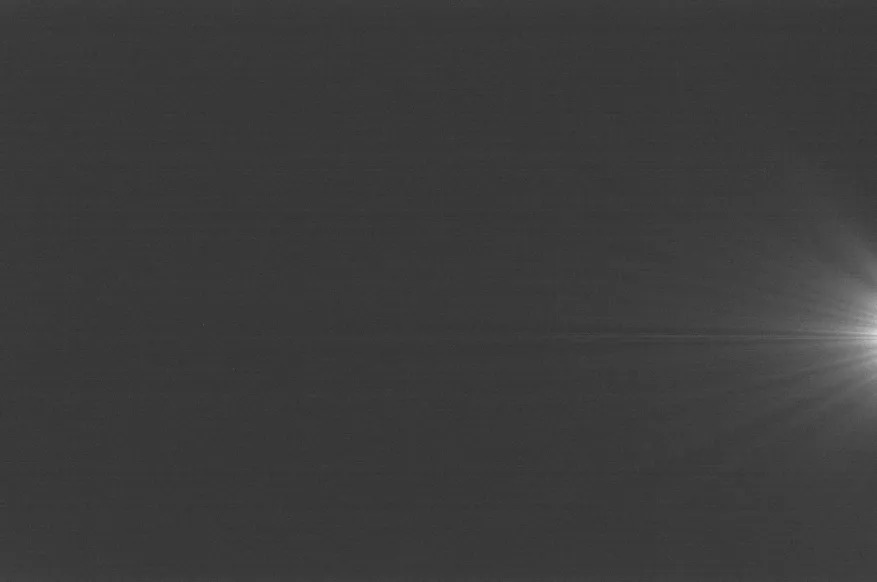 Image with amp glow, white light flare appearing on a black backdrop.