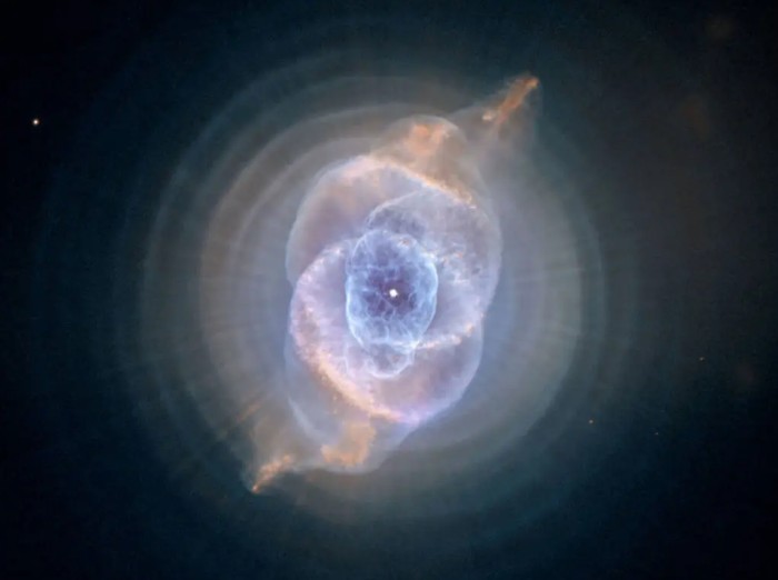 The Cat’s Eye Nebula, a bright, circular cloud of colorful gas and dust with intricate layers and structures, captured in high detail by NASA’s Hubble Space Teles