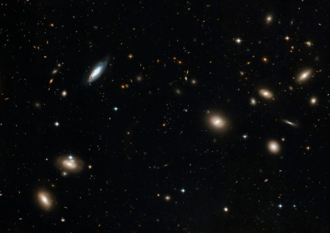 The Coma Cluster, a massive galaxy cluster containing thousands of galaxies of varying shapes and sizes, spread across a dense star field, captured in high-resolution by NASA’s Hubble Space Telescope.