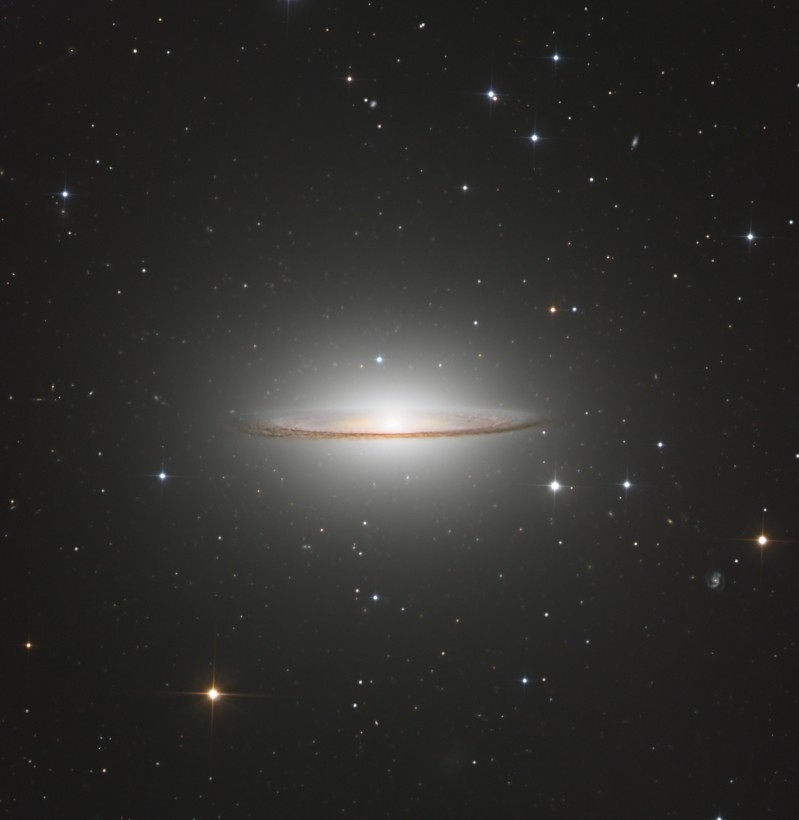 The Sombrero Galaxy, featuring a bright central bulge and a prominent, dark dust lane that gives it a hat-like appearance, captured in striking detail by astrophotographer Drew Evans.