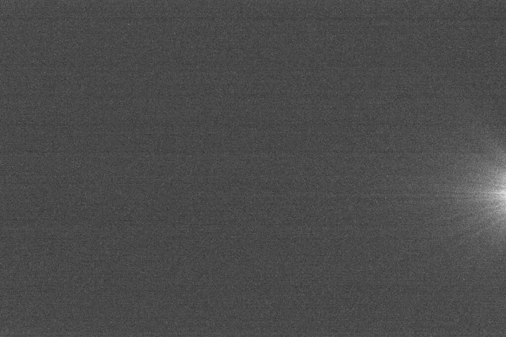 A dark frame with no details/image with streaks of light known as Amp Glow flaring from one side.